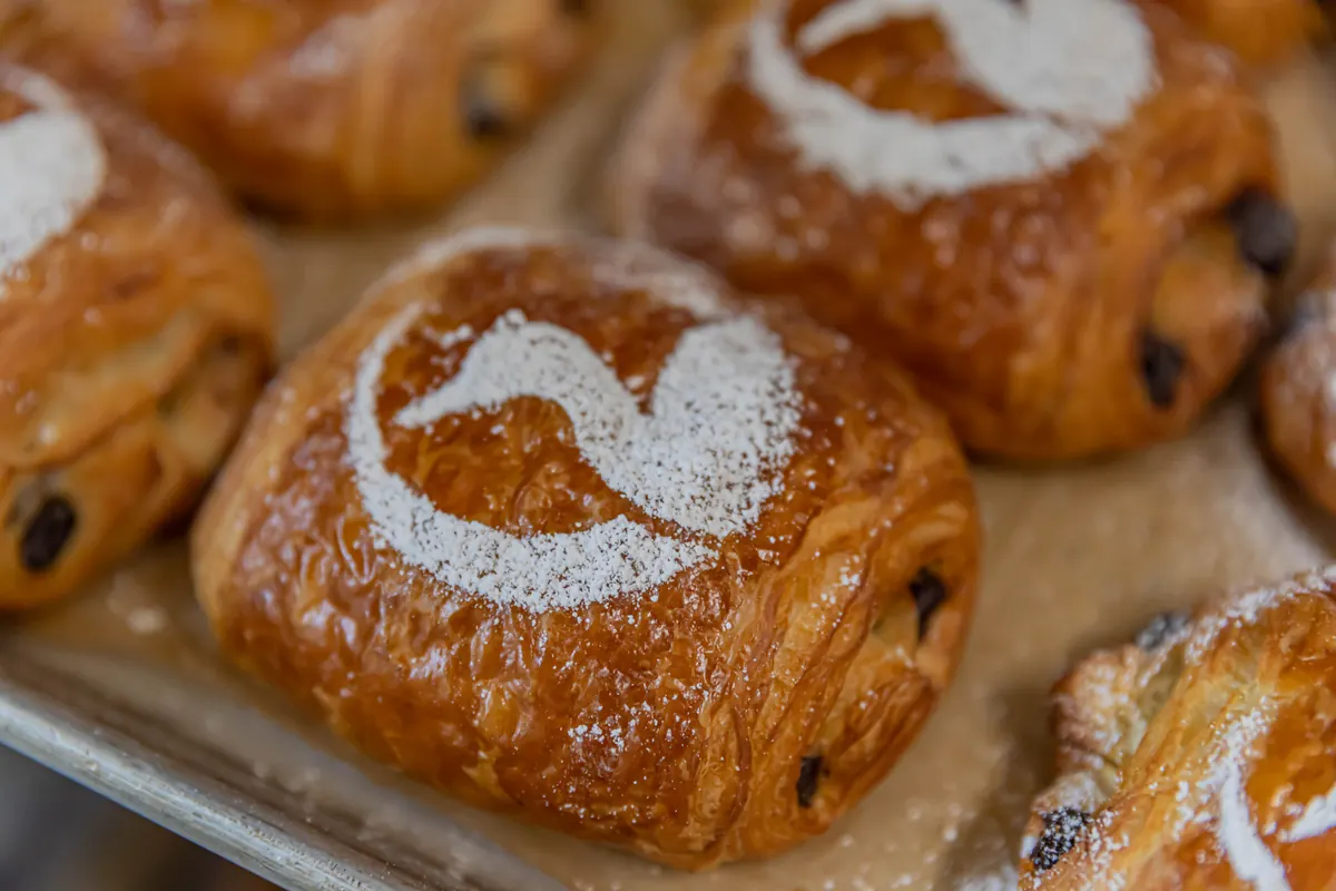 Chocolate croissants dusted with a powdered-sugar loon